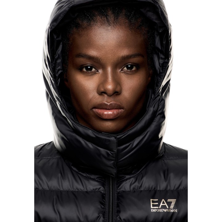 Detalle frontal de chaqueta negra EA7 de mujer con capucha y logotipo