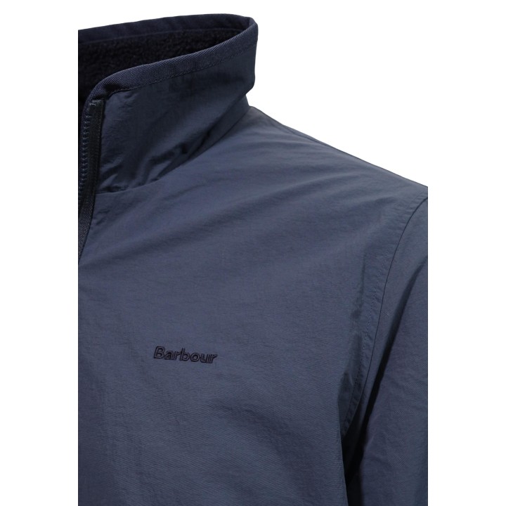 Detalle de cuello y logo Barbour en chaqueta reversible azul