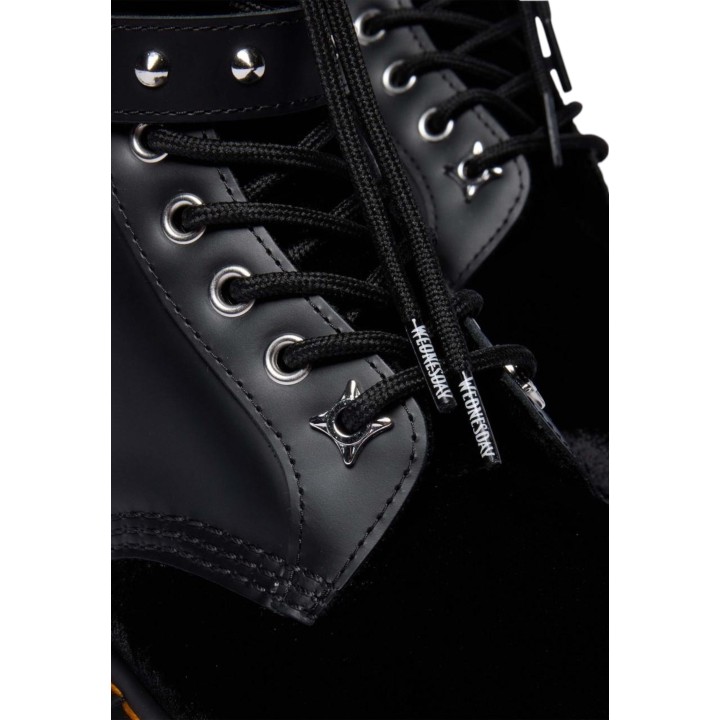 Detalle de cordones y tachuelas en botas Dr. Martens negras de mujer